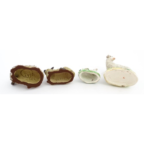 197 - Four ceramic models of sheep to include a 19thC Staffordshire hollow base lamb with bocage, a Staffo... 