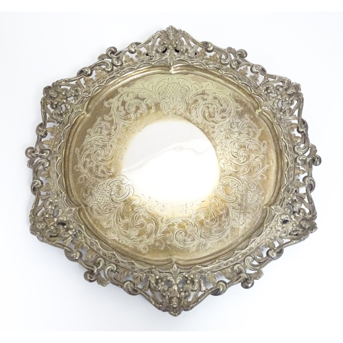 588 - Three items of silver plate comprising a salver, punch bowl and a sauce boat. Salver approx. 13