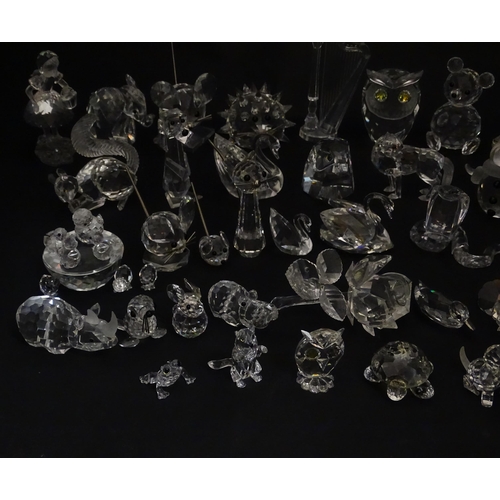 311 - A quantity of assorted Swarovski crystal ornaments to include rhino, swans, hedgehog, snail, elephan... 