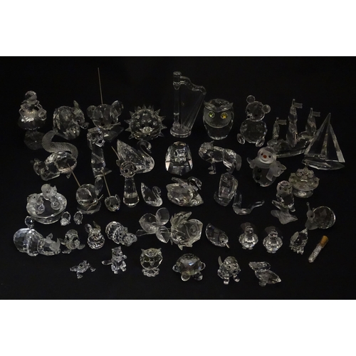 311 - A quantity of assorted Swarovski crystal ornaments to include rhino, swans, hedgehog, snail, elephan... 