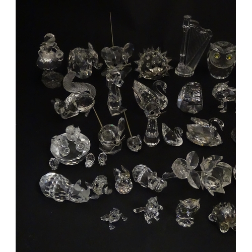 311 - A quantity of assorted Swarovski crystal ornaments to include rhino, swans, hedgehog, snail, elephan... 