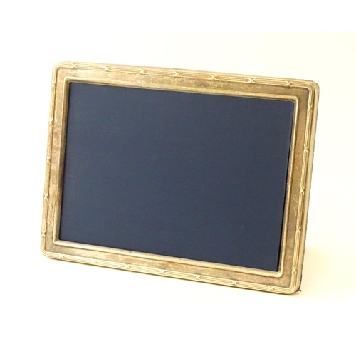 553 - Two easel back photograph frames with silver surrounds, one hallmarked Sheffield 1992, maker Carrs o... 