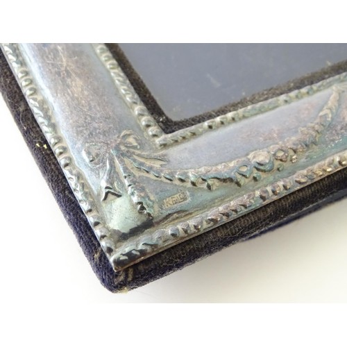 553 - Two easel back photograph frames with silver surrounds, one hallmarked Sheffield 1992, maker Carrs o... 