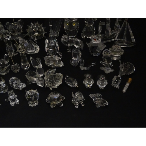 311 - A quantity of assorted Swarovski crystal ornaments to include rhino, swans, hedgehog, snail, elephan... 