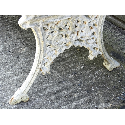 815 - Garden / Architectural : A late 19th / early 20thC cast iron garden bench with foliate decoration an... 