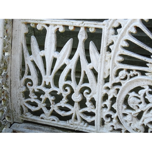 815 - Garden / Architectural : A late 19th / early 20thC cast iron garden bench with foliate decoration an... 