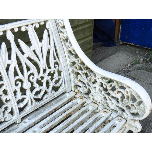 815 - Garden / Architectural : A late 19th / early 20thC cast iron garden bench with foliate decoration an... 