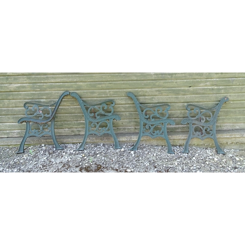 817 - Garden / Architectural : Four cast iron bench frame ends, with scroll decoration and green painted f... 