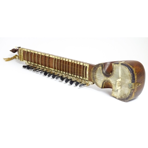 Musical Instrument : an early to mid 20thC sitar, the carved headstock ...