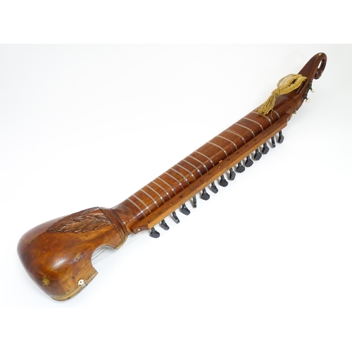 Musical Instrument : an early to mid 20thC sitar, the carved headstock ...