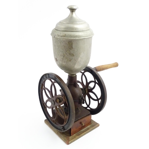 1119 - A Victorian Simplex no. 6 coffee grinder the tin hopper supported by a cast iron base with twin whee... 