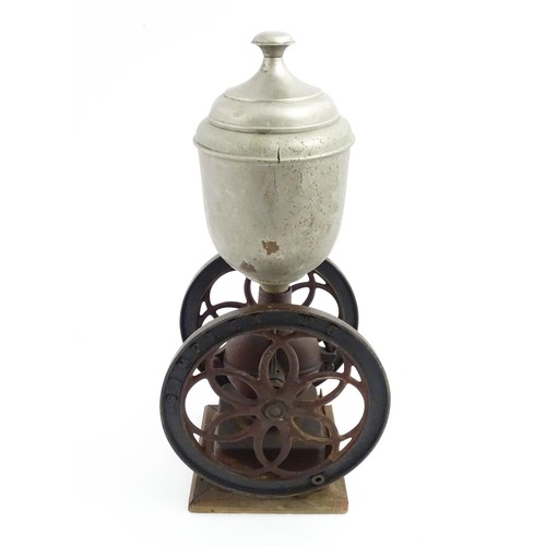 1119 - A Victorian Simplex no. 6 coffee grinder the tin hopper supported by a cast iron base with twin whee... 