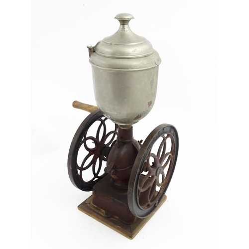 1119 - A Victorian Simplex no. 6 coffee grinder the tin hopper supported by a cast iron base with twin whee... 