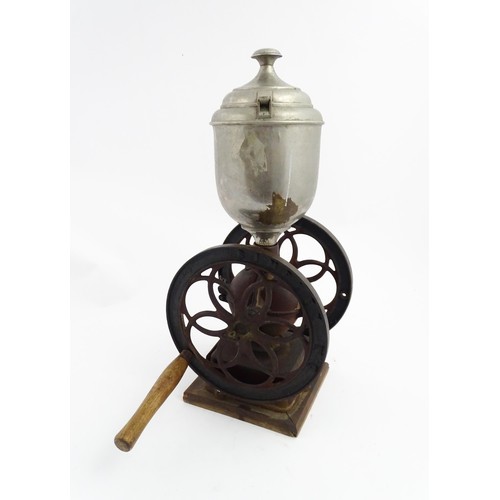 1119 - A Victorian Simplex no. 6 coffee grinder the tin hopper supported by a cast iron base with twin whee... 