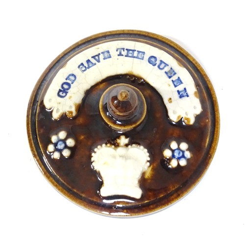 62 - A Victorian Measham bargeware advertising tobacco jar and tamper decorated with flowers and foliage ... 