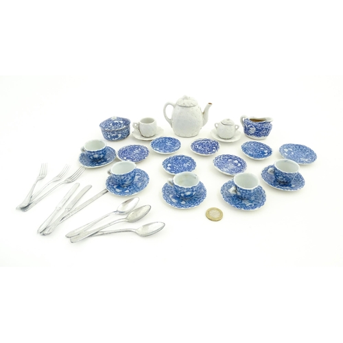 73 - A quantity of blue and white miniature tea wares to include milk jug, sugar bowl, cups and saucers. ... 