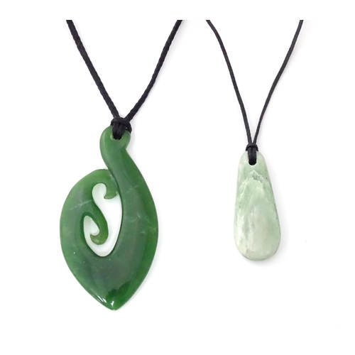 450 - A Jade coloured hardstone pendant together with another (2)