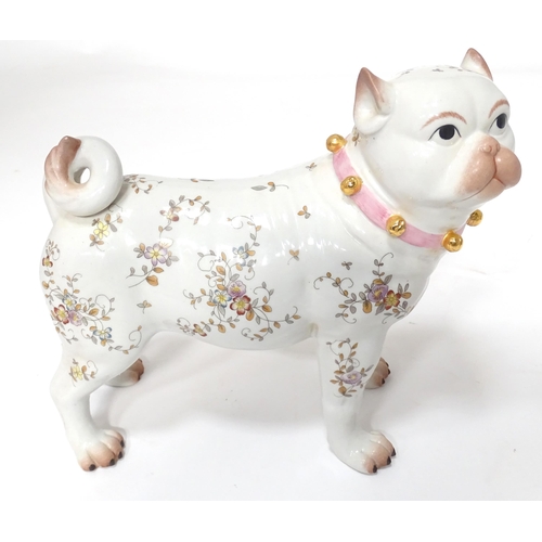 105 - A Continental model of a pug dog with floral decoration. Approx. 8