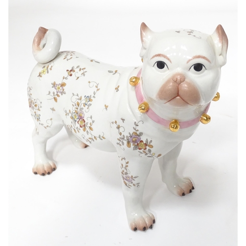 105 - A Continental model of a pug dog with floral decoration. Approx. 8