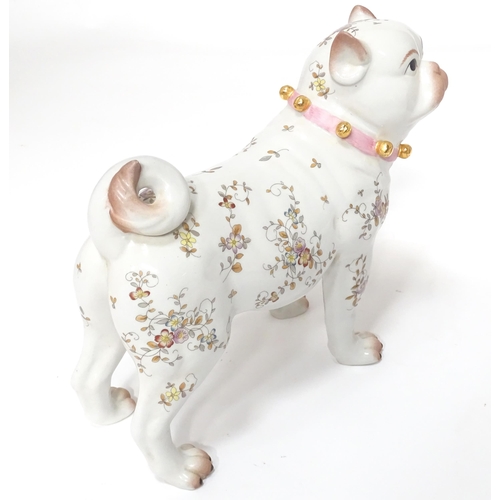 105 - A Continental model of a pug dog with floral decoration. Approx. 8