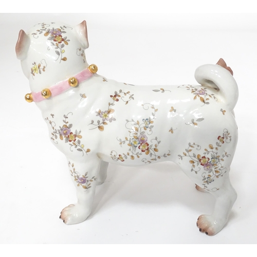 105 - A Continental model of a pug dog with floral decoration. Approx. 8