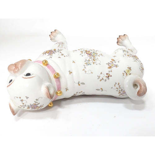 105 - A Continental model of a pug dog with floral decoration. Approx. 8