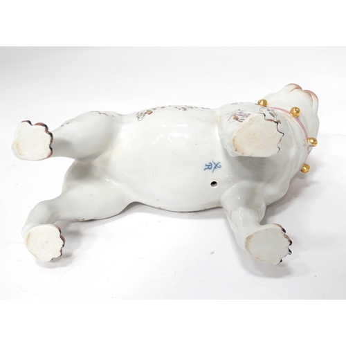 105 - A Continental model of a pug dog with floral decoration. Approx. 8