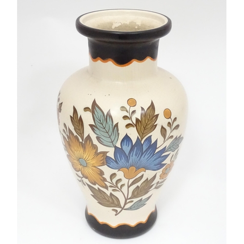 22 - A Gouda vase with floral and foliate decoration. Marked under Flora Gouda Plateel Holland Handwerk, ... 