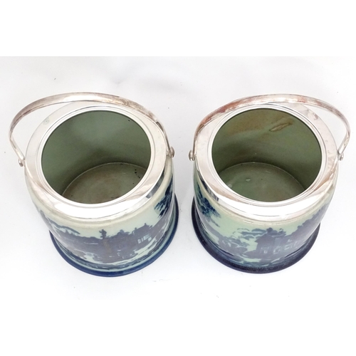 23 - A pair of blue and white biscuit barrels with silver plate lids. Approx. 8 1/2