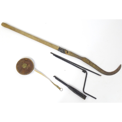 828 - A mid 20thC hedgelaying slasher with scythe blade, together with a car jack and a leather cased tape... 