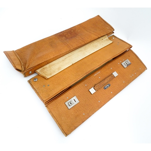 63 - An mid 20thC ' Stoawa ' folding leather suitcase, the lined interior with collapsing boards and with... 