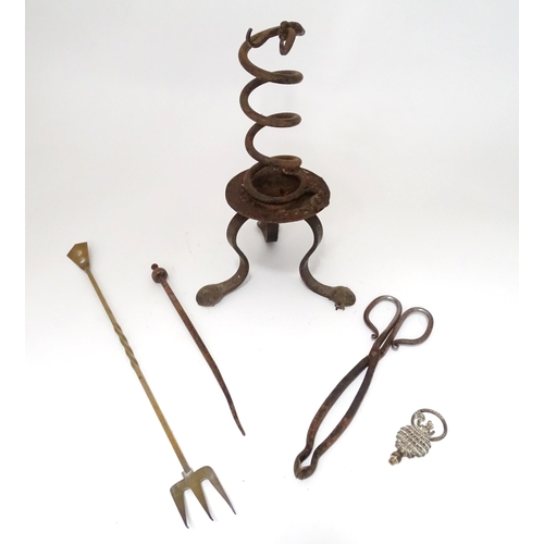 795 - A wrought iron fire tool set, comprising tongs, poker and stand, together with a brass toasting fork... 