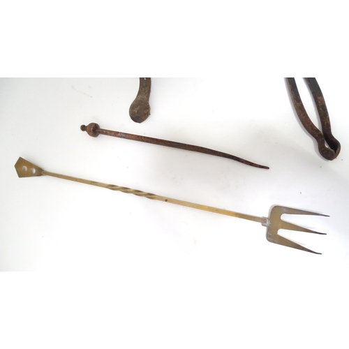 795 - A wrought iron fire tool set, comprising tongs, poker and stand, together with a brass toasting fork... 