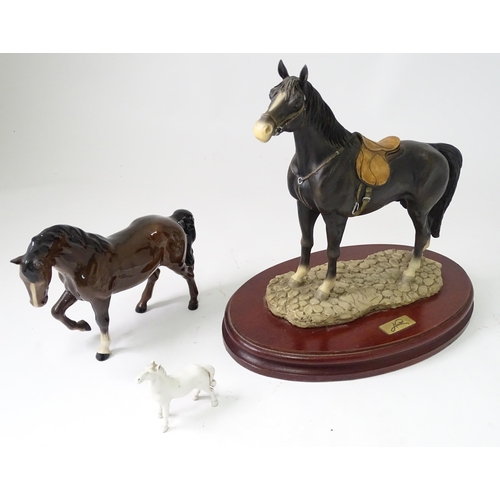 814 - Three models of horses comprising a Beswick pony, a small white horse, and a resin example with a pl... 