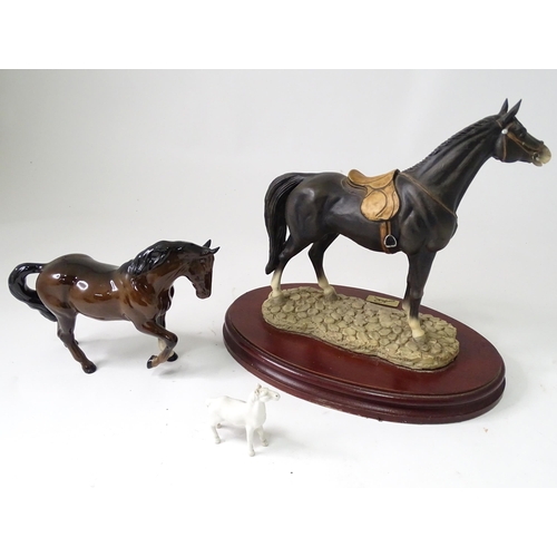 814 - Three models of horses comprising a Beswick pony, a small white horse, and a resin example with a pl... 