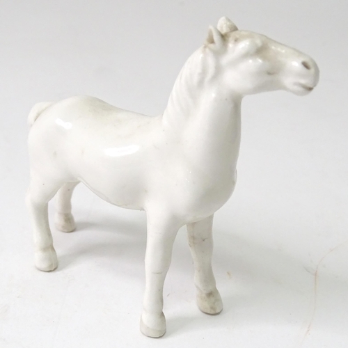 814 - Three models of horses comprising a Beswick pony, a small white horse, and a resin example with a pl... 