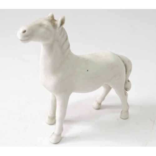 814 - Three models of horses comprising a Beswick pony, a small white horse, and a resin example with a pl... 