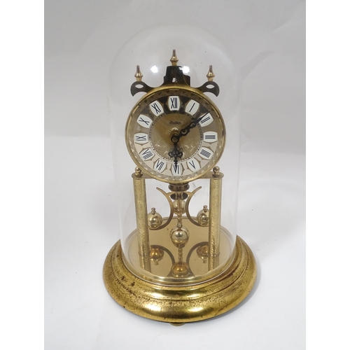 82 - A late 20thC anniversary / torsion clock by Haller. Approx. 11 3/4