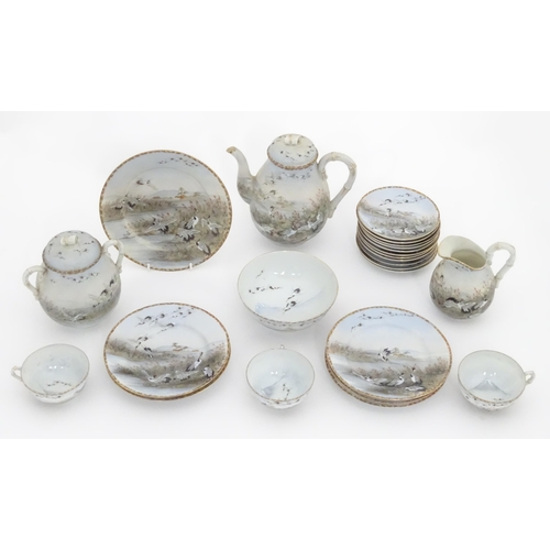 822 - A quantity of Japanese tea wares decorated with crane birds in flight to include teapot, sugar bowl,... 