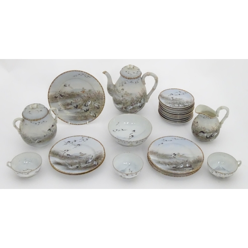 822 - A quantity of Japanese tea wares decorated with crane birds in flight to include teapot, sugar bowl,... 