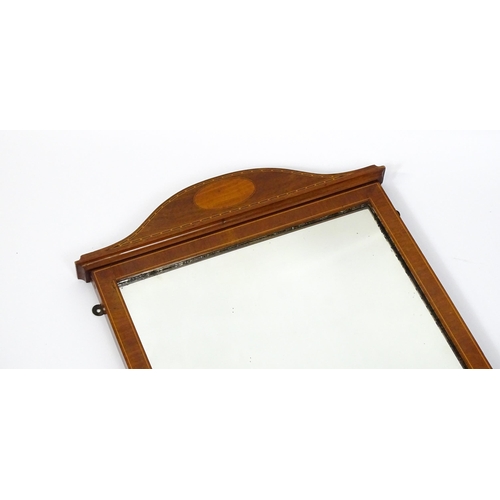 13 - An early 20thC mahogany wall mirror with satinwood marquetry decoration. 19