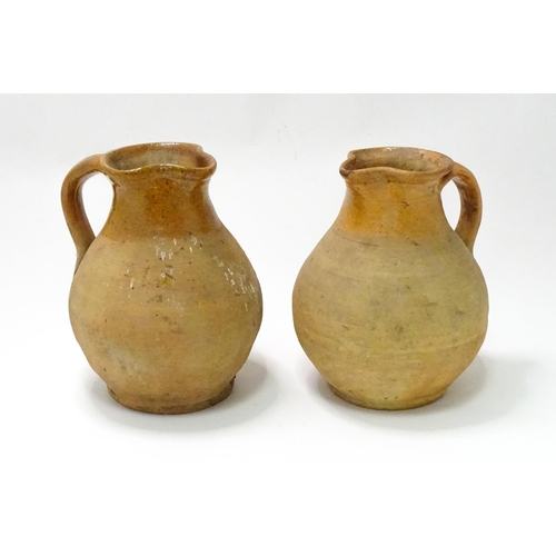 21 - Two salt glazed jugs of bulbous form, each with a loop handle. Approx. 9 3/4