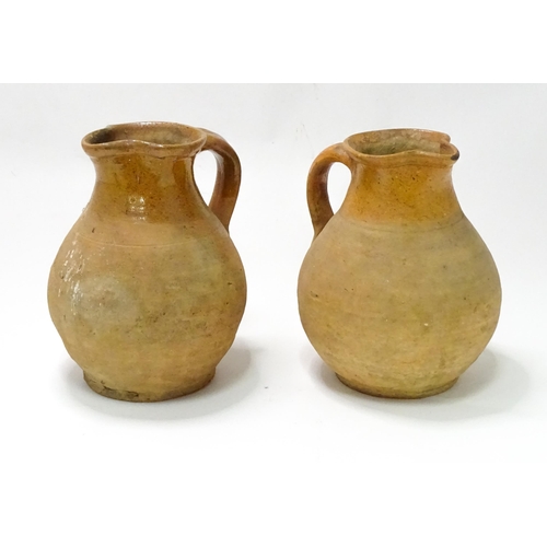 21 - Two salt glazed jugs of bulbous form, each with a loop handle. Approx. 9 3/4