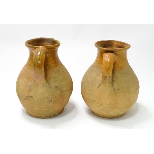 21 - Two salt glazed jugs of bulbous form, each with a loop handle. Approx. 9 3/4