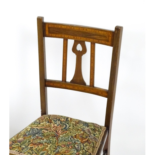 25 - An early 20thC mahogany side chair with satinwood crossbanding. Together with an Art Nouveau side ch... 