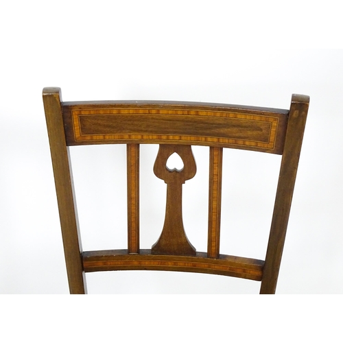 25 - An early 20thC mahogany side chair with satinwood crossbanding. Together with an Art Nouveau side ch... 