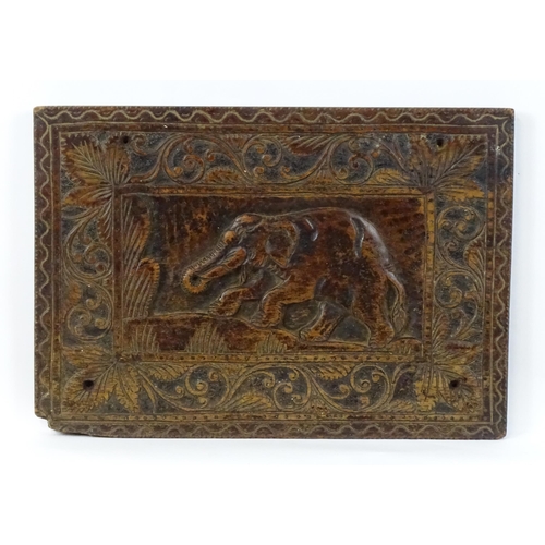 840 - A carved wooden panel depicting an elephant with foliate border. Approx. 14 3/4