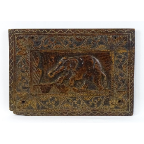 840 - A carved wooden panel depicting an elephant with foliate border. Approx. 14 3/4