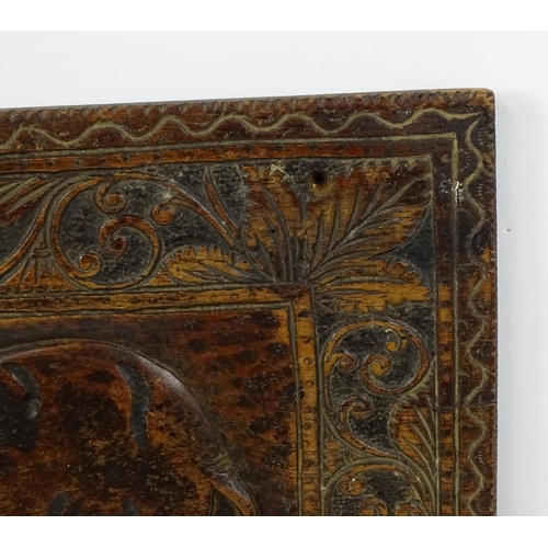 840 - A carved wooden panel depicting an elephant with foliate border. Approx. 14 3/4