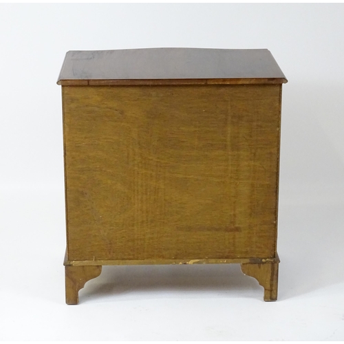 98 - A late 20thC mahogany serpentine fronted chest with a brushing slide, above a hinged door raised on ... 